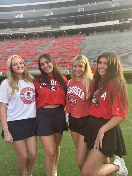A student in the stands at a college stadium.